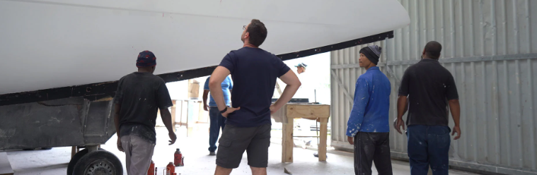 A view of technicians observing a luxury yacht 