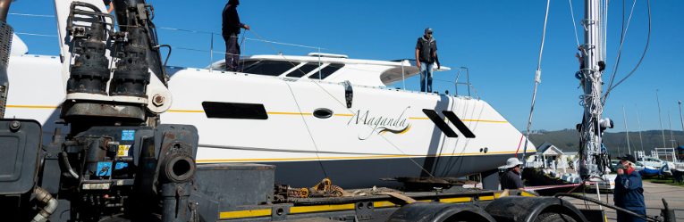 Workers standing aboard a yacht