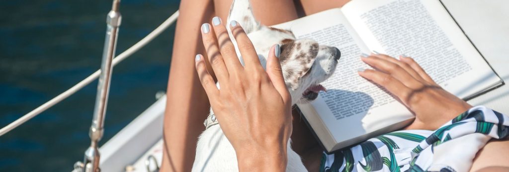 A dog captured watching its owner read a book